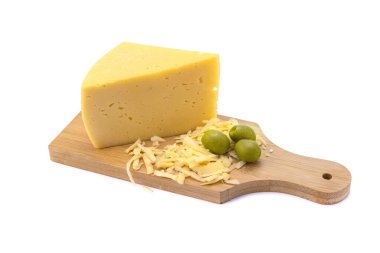A piece of hard yellow gouda cheese and grated cheese with olives on a wooden board. close-up, isolated on a white background.selective focus clipart