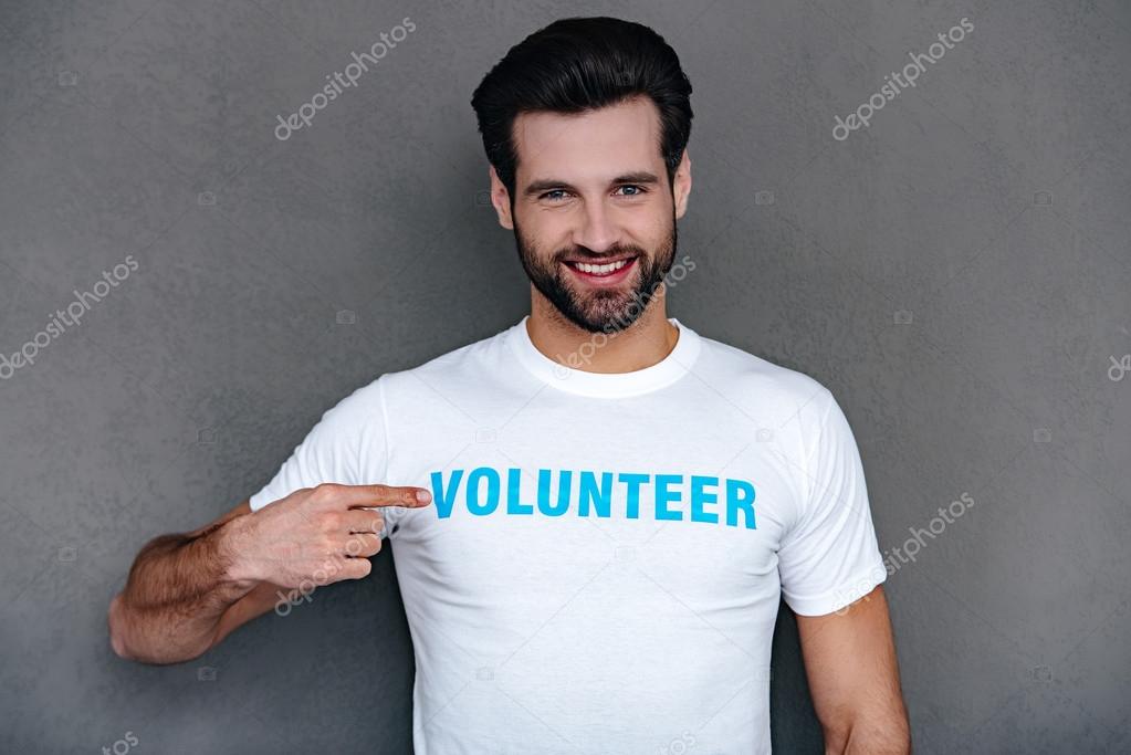 man pointing at volunteer title on his t-shirtand