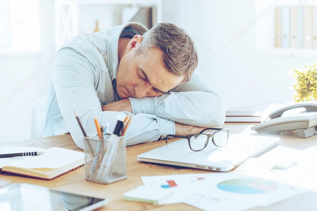 tired mature man sleeping in office