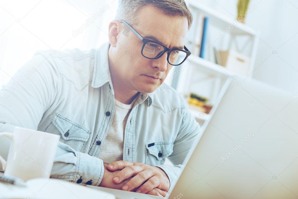 mature man working with laptop