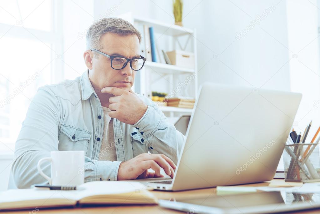 mature man working with laptop