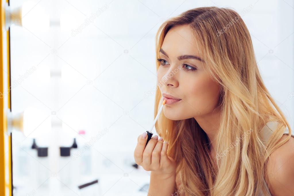 young woman applying make-up