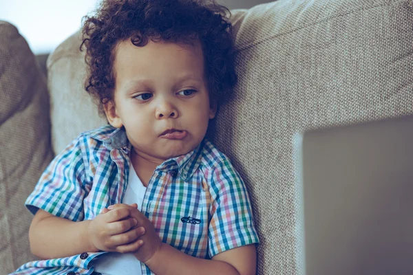 Baby boy with laptop at home — Stock Photo, Image