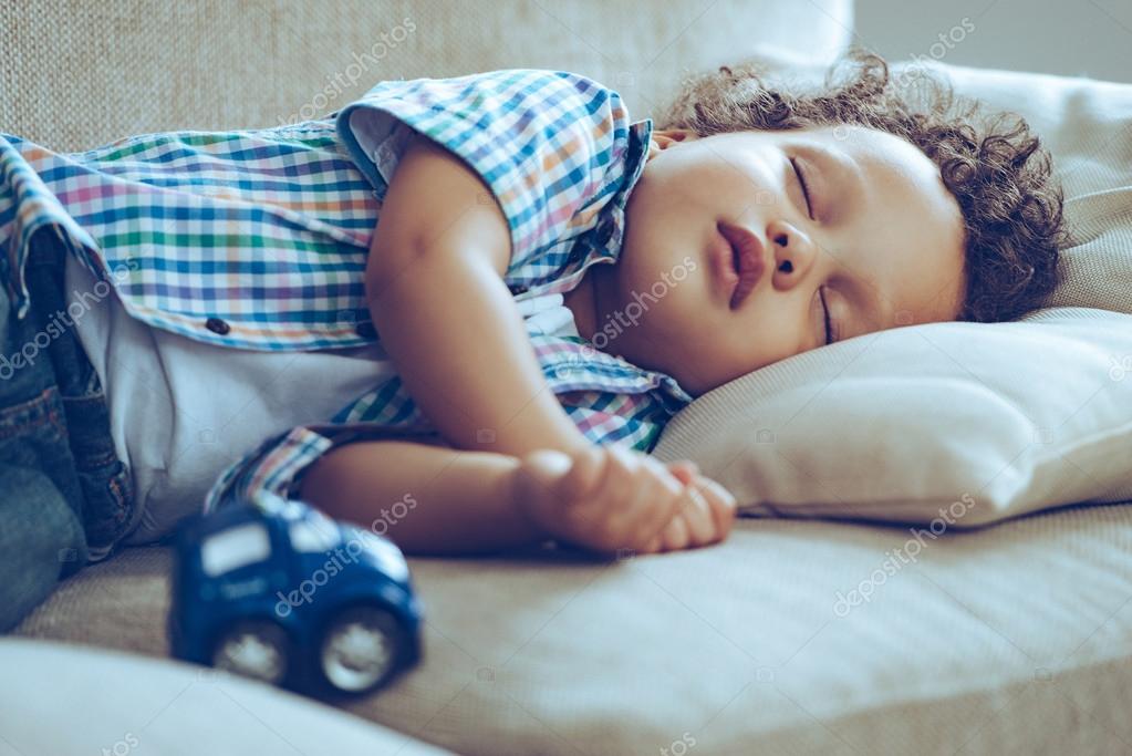 Baby boy sleeping on couch — Stock Photo © gstockstudio 102064238