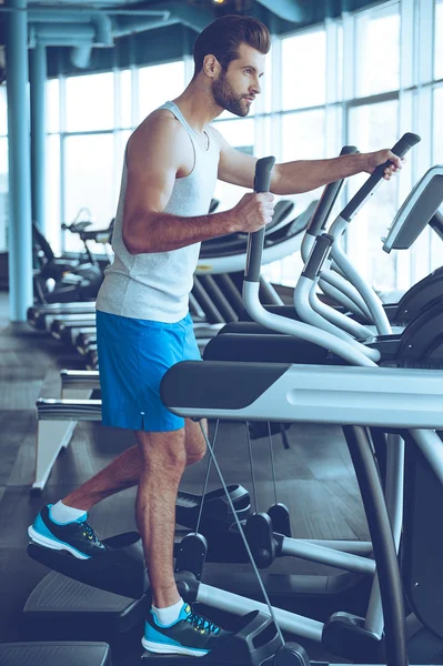 Young man on stepper at gym — Stock Photo, Image