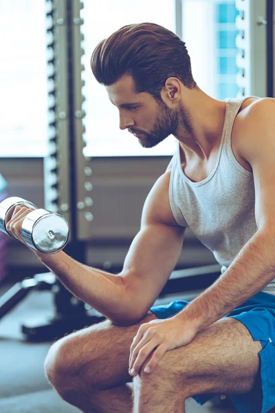 Handsome man with dumbbell at gym — Stock Photo, Image