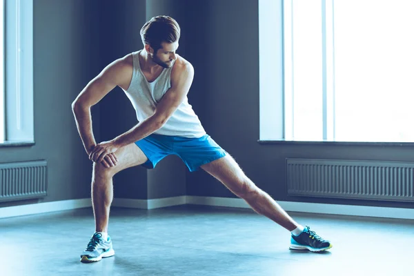 Young handsome man stretching — Stock Photo, Image