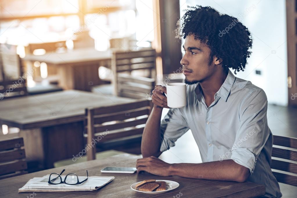 African man sitting in cafe