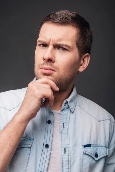 Young man with  hand on chin — Stock Photo, Image