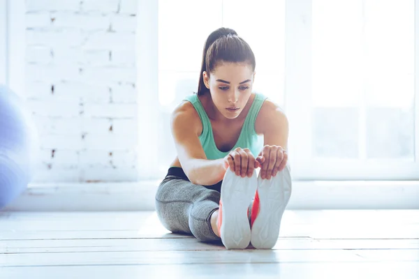 woman in sportswear stretching