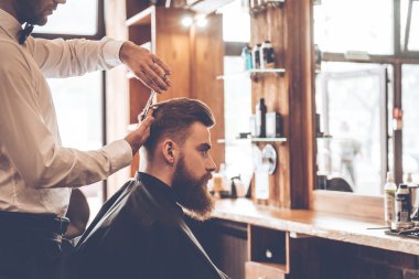 young bearded man with hairdresser