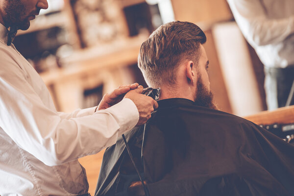 young bearded man with hairdresser