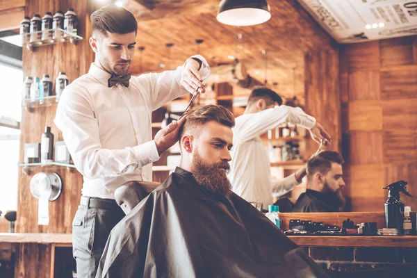 young bearded man with hairdresser