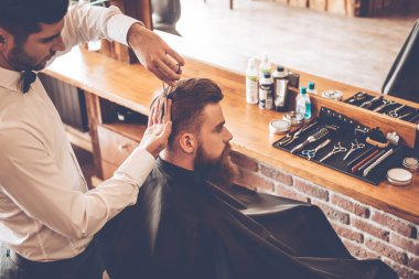 young bearded man with hairdresser
