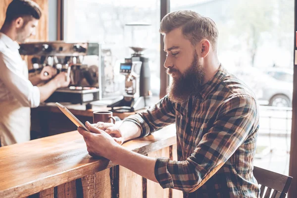 Man using  digital tablet at bar — Stock Photo, Image