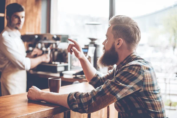 Bebaarde man met koffie en barista — Stockfoto