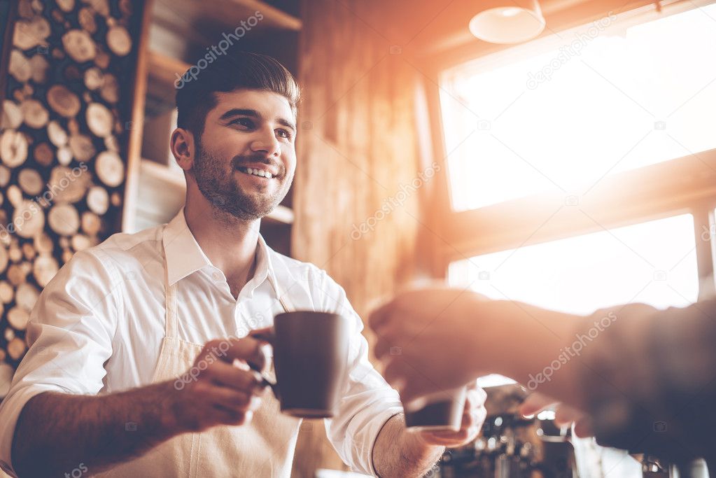 Barista in apron at cafe