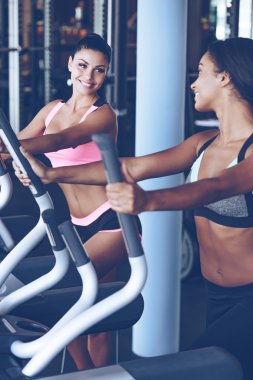 Young beautiful women working out on stepper