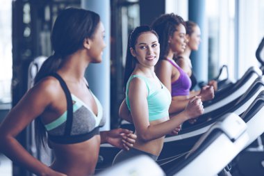 young beautiful women  running on treadmill 