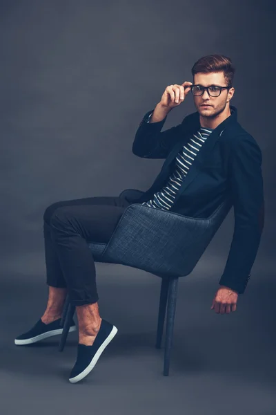 Handsome man sitting in chair — Stock Photo, Image