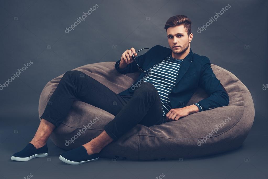 Person sitting in bean cheap bag