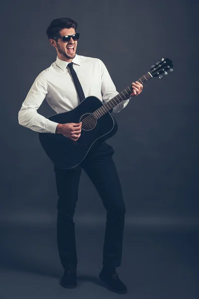 Man in sunglasses playing guitar — Stok fotoğraf