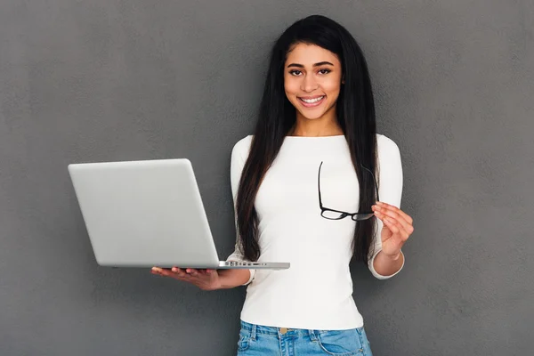 Aantrekkelijke jonge vrouw bedrijf laptop — Stockfoto