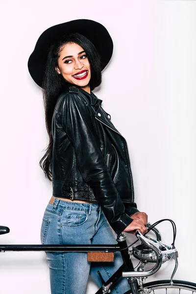 Beautiful young woman near black bicycle — Stock Photo, Image