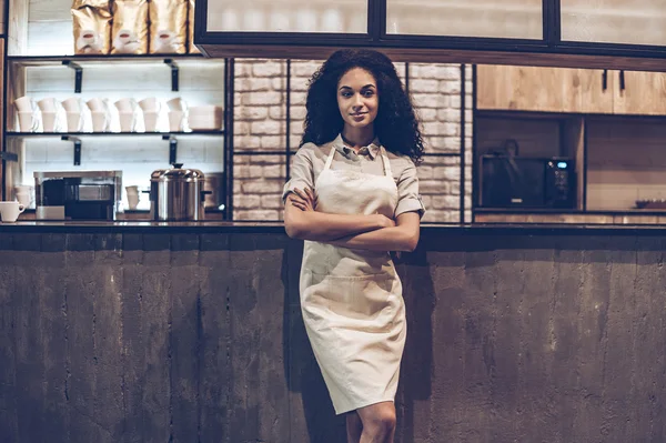 Young cheerful woman in apron — Stock Photo, Image