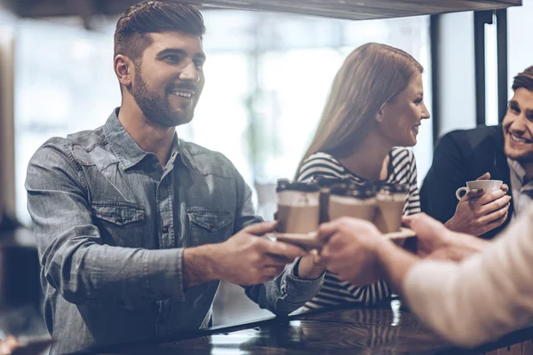 Barista passerende koffie kopjes — Stockfoto