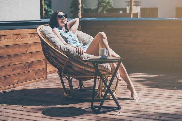 woman relaxing in a big comfortable chair