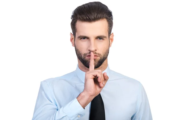 Mann hält Finger auf Lippen — Stockfoto