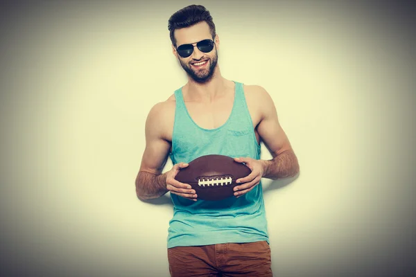 Hombre sosteniendo pelota de fútbol americano — Foto de Stock