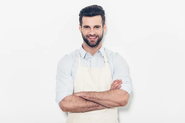 Man in apron keeping arms crossed — Stock Photo, Image