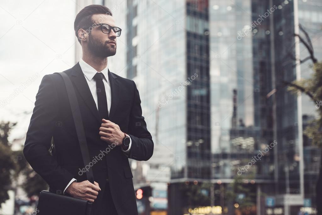 man in full suit walking along the street