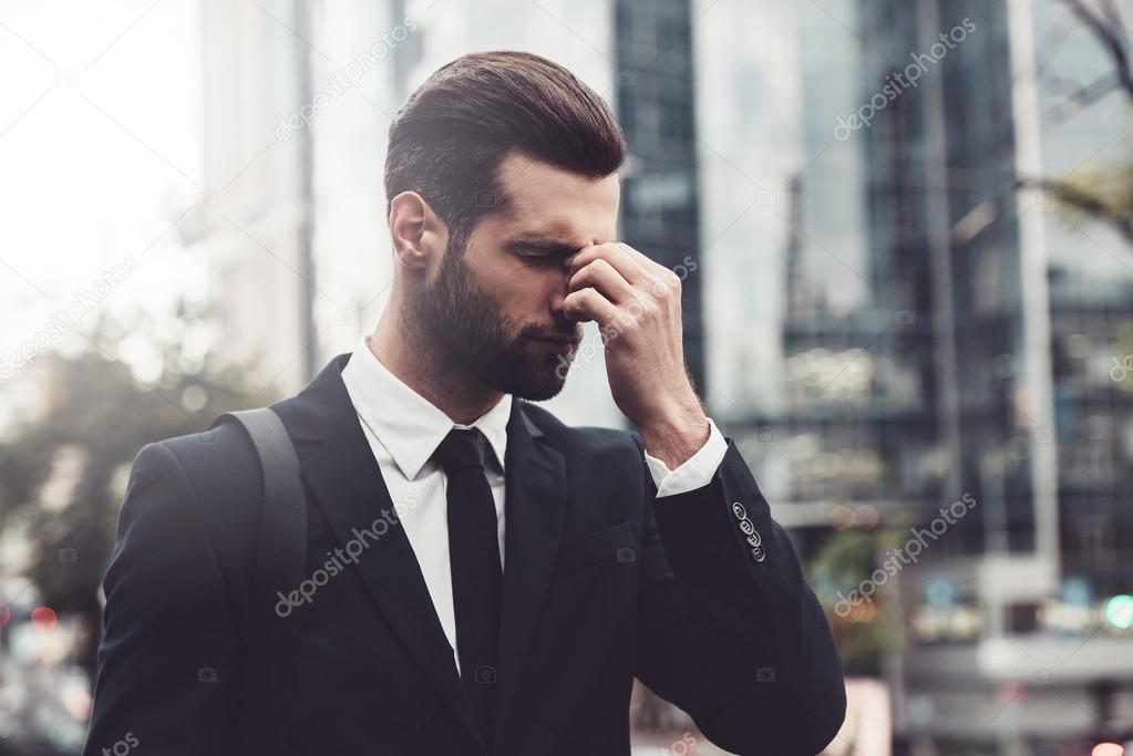 man in formalwear stressed and tired.
