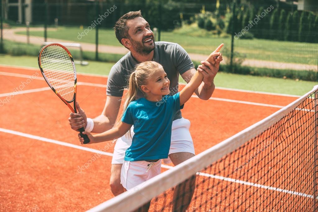 Father and daughter on tennis court Stock Photo by ©gstockstudio 115468618