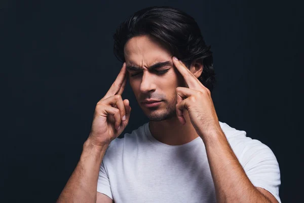 Man touching his head with fingers — Stock Photo, Image