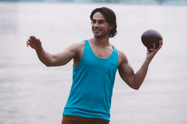 Man throws American football ball — Stock Photo, Image