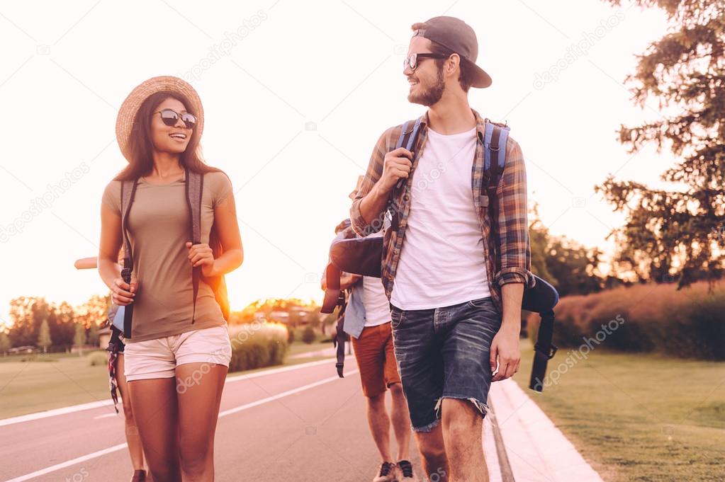  people with backpacks walking together 