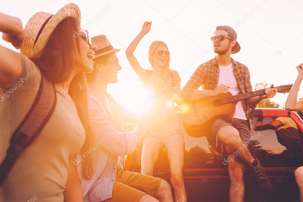  cheerful people dancing and playing guitar