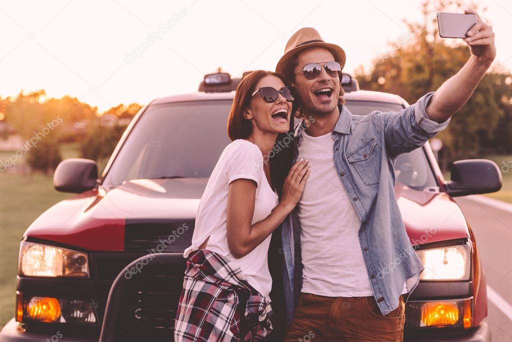  couple leaning at their pick-up truck 