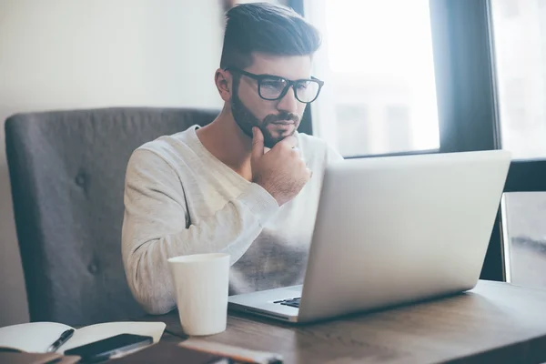 Pensive man working with laptop — Stock Photo, Image