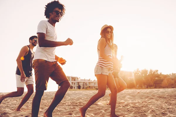 Jonge mensen lopen op strand — Stockfoto