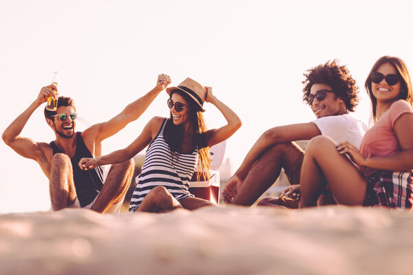 young people drinking beer and talking