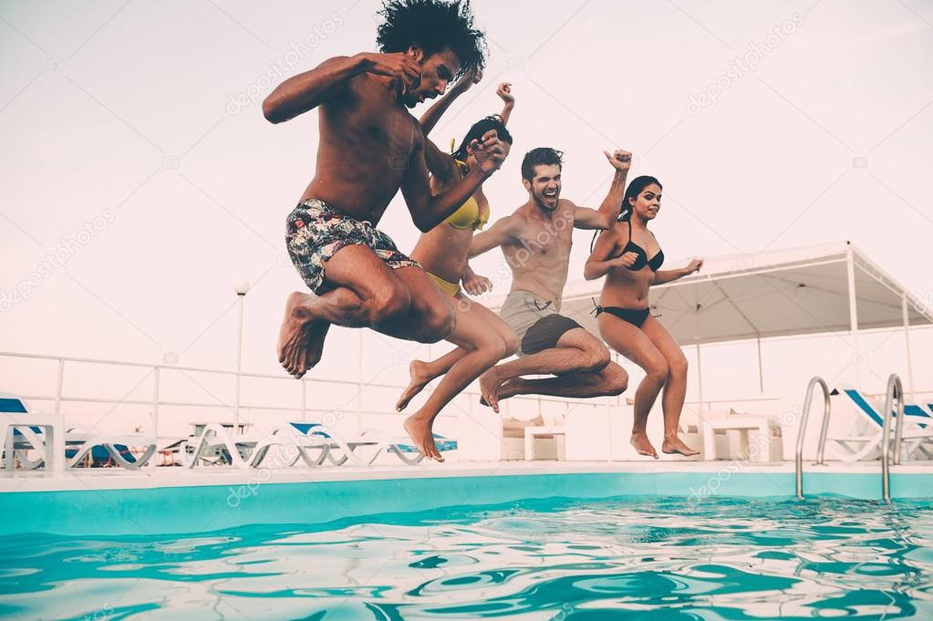 best friends jumping into swimming pool