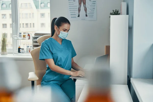 Beautiful young female nurse in protective mask — Stock Photo, Image