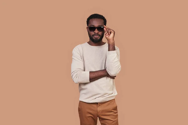 Handsome young African man in casual closing adjusting eyewear — Stock Photo, Image