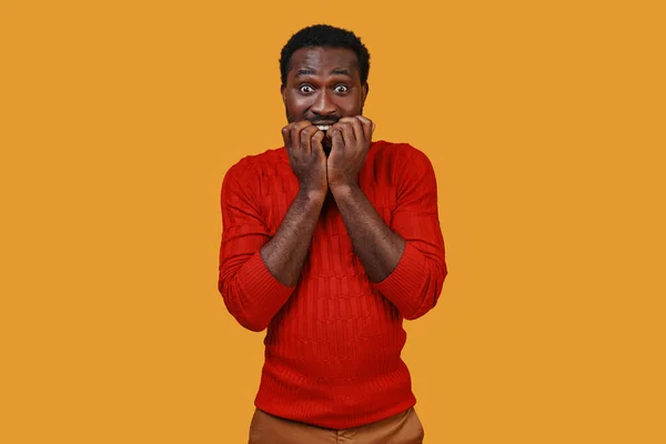 Frustrated young African man in casual clothing making a face and looking at camera — Stock Photo, Image