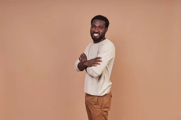 ハンサムな若いですアフリカ人男でカジュアルな閉鎖保持腕交差と笑顔 — ストック写真